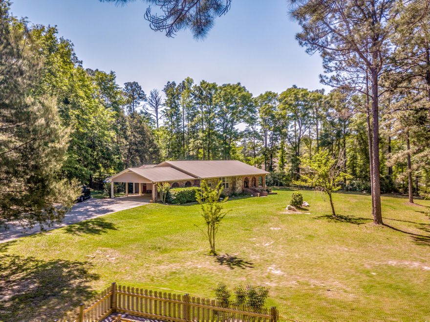 Nestled atop the hill in Nearing Hills Subdivision is a fabulous home that you'll be proud to call your own. You're minutes to all the schools, shopping and I-10 but still secluded and have that country feel. The home is a spacious 3 bdrm/2 bath split plan that features a kitchen/dining area that is the heart of the home. It has a 4X8 island, stainless appliances including fridge w/water & ice in door and convection oven, subway tile backsplash, pantry and cabinet/counter space galore & glass front cabinets. The large living room has built-in books shelves and storage and is open to the dining area. The split bdrm plan features a large master suite w/walkin closet and a mstr bath shower that's 7x4 w/2 shower heads There's an office off the master/living room with French doors and built-in bookshelves. This home has so much character and charm - even in the laundry/craft room where you'll find a sliding barn door and wood beams for shelves and a folding table that the seller built himself in the shop outside. Not only is there a 16 x 28 workshop on the 2 acre parcel but there's also a nice stone fire pit and a fenced garden for growing your own vegetables. It's truly a lovely home and has been well maintained with new laminate flooring in the kitchen/dining area/living room, new tile in the laundry room, freshly painted interior, and new subway tile backsplash in the kitchen. Please call to view this wonderful home today - you will not be disappointed.