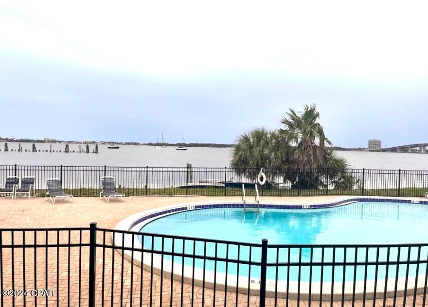 Minutes away from the White Sandy Beaches, Shell Island, and St. Andrews State Park! Sun Harbor ground floor condo has waterfront and sunset views from your living room, patio and pool. Patio opens directly to waterfront pool and steps away to the Bay and docks. Unit is near all that Panama City, and Panama City Beach has to offer. This furnished Condo is near the Historic downtown Panama City, and across the street from Gulf Coast College, and across the bridge from the Naval base on Thomas Drive. Within minutes to Tyndal AFB and Pier Park. Full service onsite Marina on property near completion featuring a restaurant and convenience store. Includes all utilities. Tenant pays for internet! Onsite laundry.