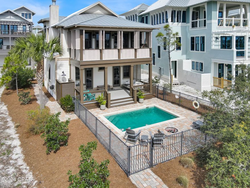 Coastal living at its finest! Step into your dream home with breathtaking, unobstructed bay views and custom, must-see details. The first-floor sanctuary boasts a private primary suite with a porch and poolside view, while the tailor-made bunk room with built-in storage is a delightful bonus for guests. Convenience meets luxury with easily accessible laundry and a full bath from the pool area. Upstairs unveils a perfect blend of a kitchen/living/dining combination featuring a cozy fireplace, hardwood floors, and top-notch stainless steel appliances. An entertainer's paradise, this space opens to an oversized Key West-style porch with louvered shutters and an outdoor BBQ area, all overlooking a private pool and the stunning vista beyond. On the main level, discover a convenient half bath, two guest rooms with a private porch, and a jack-and-jill full bath. Ovation, the epitome of coastal living, provides two bayside docks for boating and kayaking, tennis courts, bayfront and gulf-side pools, and a boardwalk leading to uncrowded, pet-friendly beaches. Ready to turn this dream into reality? Call for a showing and embark on a personalized tour of this exceptional area. Your coastal oasis awaits!