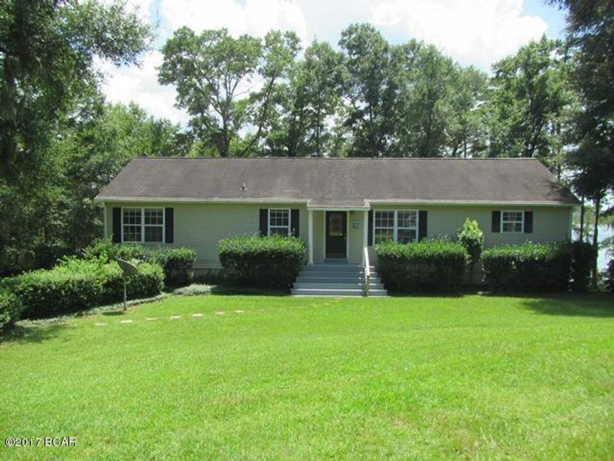 LAKEFRONT & PRIVACY  !!  This is a combination that is difficult to find. Very nice 3 Bdr 2 Bth home on the North end of Beautiful Compass Lake. This lot has an incredible 965 ft of waterfront, and is the only residential lot on the whole rd, creating privacy that is unheard of on Compass Lake, and within walking distance to Clubhouse. The view from your Balcony and Dock is facing SouthWest giving you Sunset views all year. Comfortable Floor Plan all on Entry Level PLUS a full 1792 sq ft Walkout Basement with a Single Car Garage. Basement is all finished, and could be converted to use however you want. Separate Living Room, Dining Room, Family Room with Gas Fireplace, Big Open Kitchen with doorway to Dining, Master Bdr has Walk-In Closet, Master Bth has Tub, Separate Shower, Dbl Vanities, Master Bedroom has Glass Doors opening onto Balcony. All interior doors are 36" wide. open Balcony all across back of home overlooking Compass Lake, 60' long Dock over Lake with 12' x 12' Gazebo at end. This home is within Â¼ mile of the main Lodge with Restaurant, Swimming Pool, Tennis Courts, Horseback Riding, etc