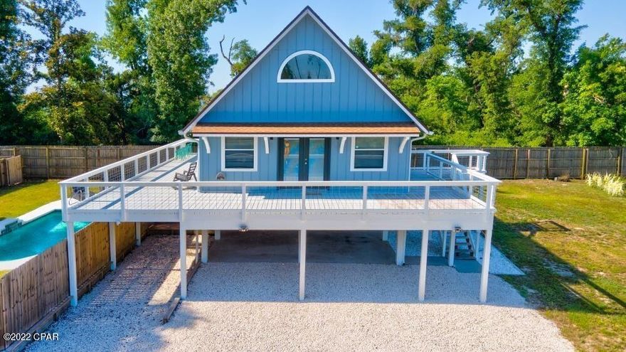 Home comes FULLY FURNISHED! Home has deeded access through private back walkway to Deerpoint Lake and a gorgeous POOL, no HOA, & quiet dead end street, this home is the definition of quiet and relaxed living. You will not find another home like this with its open concept living space that is perfectly designed for maximizing your living space. The lower level is designed in a way so you have a place to park your cars and function as a garage/workspace. The homeowner made some updates and additions to the home in the past 6 months: Replaced 6 sheets of siding, new paint full exterior including deck, new railing throughout entire deck and stairs, new refrigerator and a stove, new front entry door and hardware, & a new 10x10 storage room added below. shower. This home also features a private backyard area with a beautiful inground pool with freshly painted deck. This is the perfect space for entertaining family and friends in the Florida sunshine. This home is located in a safe and quiet neighborhood in Deerpoint Lake with boat ramp access, schools, and grocery stores for your convenience! There is an easement in the back corner of the property to walk directly to the lake.