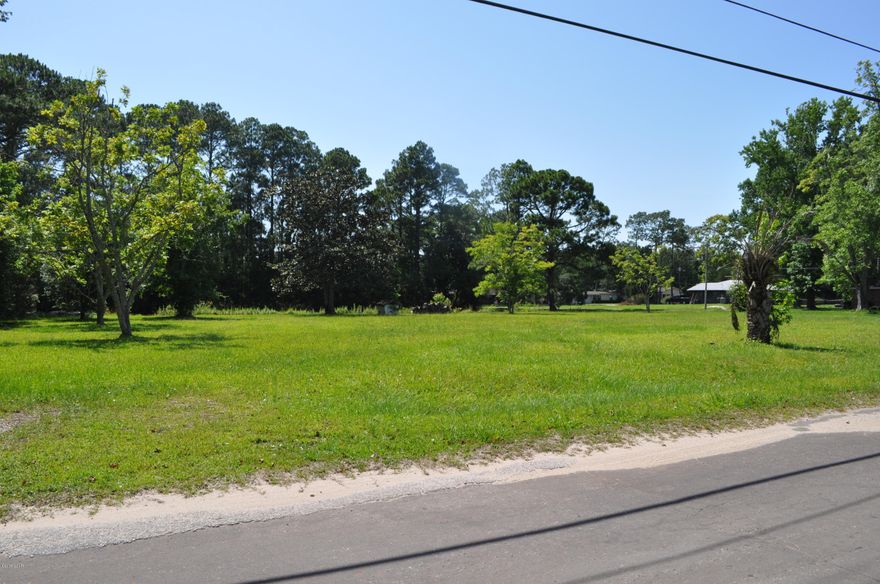 1.72 acres and a pond in Panama City! Build your dream home or subdivide and build several for an investment. Situated on a corner, this property is in the very quiet Highland Park area close to schools, shopping, medical facilities and much more.  There is a deep well on the property and sewer tap fee already paid.   All info is approx. and must be verified by Buyers if important.