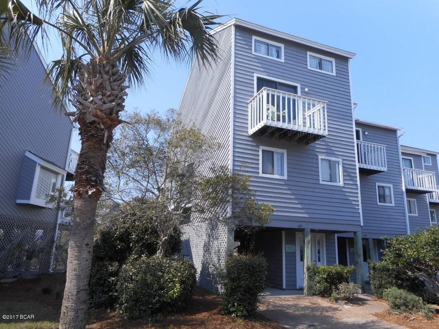 REDUCED!! Gated Gulf Front Community this Barrier Dunes Fixer Upper is priced to sell. Being Sold ''AS IS''.  This FURNISHED 2 BR+ LOFT and 2.5 Bath townhome has 1,593 SF living area, overlooks a pond and offers a glimpse of the gulf. The main floor offers living, dining, kitchen and half bath. There is a fireplace in the living area. Upstairs is Master Bedroom with bath and balcony; and a second bedroom and full bath. Access the Super Loft area from wall ladder at end of hallway. The loft has 3 twin beds and a full bed. The children will love it. Large balcony off the living room and upper balcony off master bedroom. Parking under home on concrete pad. Social area, outdoor shower & storage room located in this area. Barrier Dunes community offer 2 pools, tennis courts, ponds playground area and the Beach. Check it out. Being Sold "AS IS".