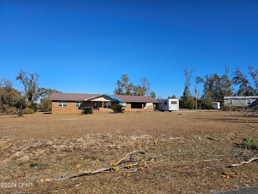 CALLING ALL INVESTORS!  Property was hit by the recent tornado and lost the top off of the detached carport/shop area, pole barn was destroyed, pool needs cleaning, fencing is in need of repair and the roof on the front porch needs to be repaired.  The home is in great shape overall.  4/2 on the outskirts of town located on 2+/- acres. There is a bonus room here that could easily made into a fifth bedroom with an added closet.