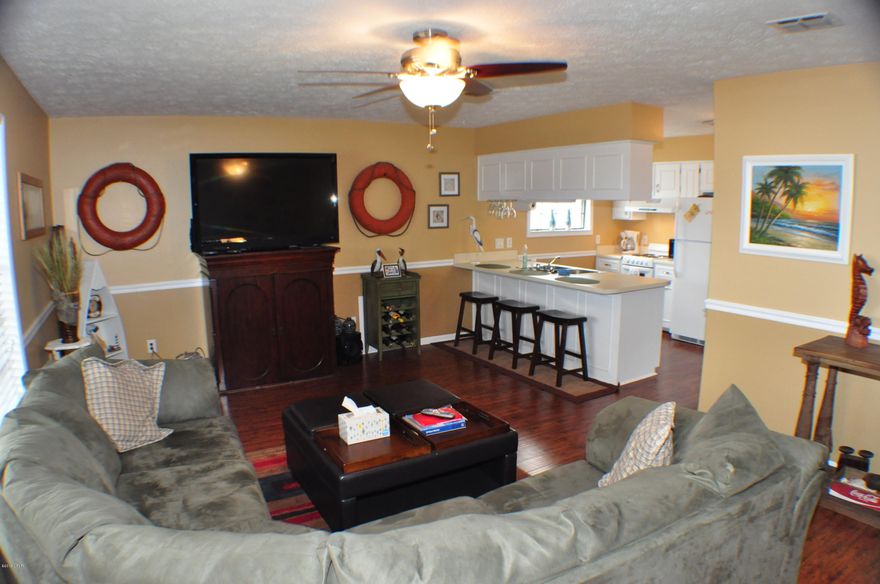 Unbelievable price for this recently upgraded Greenwood Estates condo!  This is a 2BR/1BA unit on the second floor, fully furnished and move-in ready.  Upgrades include wood laminate flooring, fresh paint, washer and dryer, updated kitchen and plenty of closet space.  This unit is on the second floor and overlooks the pool, but the boat dock on Grand Lagoon is just a few steps away and sellers say you can rent a boat slip through another owner when available.  This is a deep water lagoon with bay and gulf access!  This complex is convenient to shopping, dining, state park, and more!  Best price for an updated unit in Greenwood Estates!  All info is approx. and must be verified by buyers if important.  NOT on rental program, owner used.