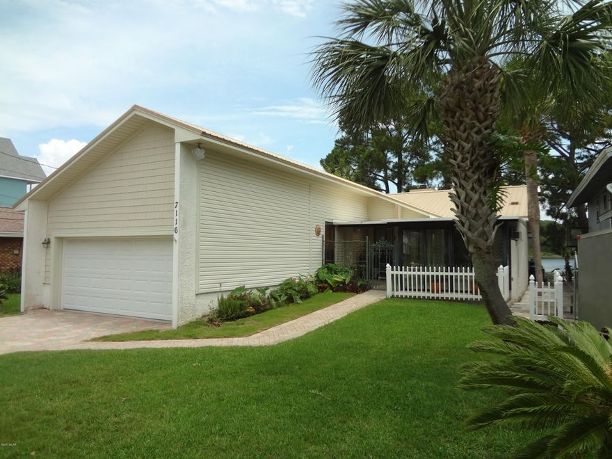 Beach home located directly on the waters of Grand Lagoon. Enjoy living near the beach with all the South Lagoon area has to offer. Boat to the Gulf in minutes. Beautiful views of the Lagoon with easy Bay and Gulf access from your own boathouse. Home has been kept up very well and offers, a metal roof installed Oct 2013, new Hickory hardwood flooring, remodeled master bath with all stone shower and flooring, three bedroom, large living area, sun room, breakfast room, garage and sprinkler system for your landscaping.  Please call for your private viewing.