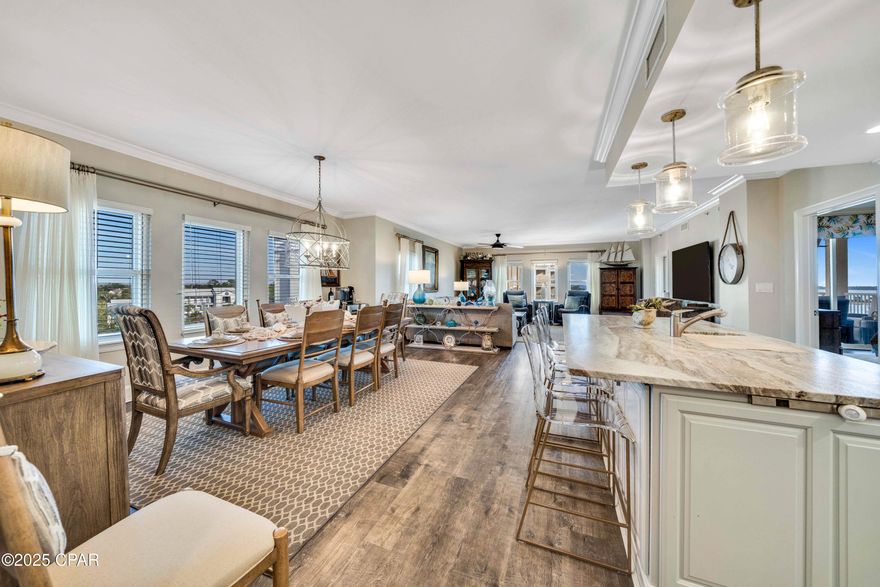 Experience FULLY FURNISHED luxury waterfront living in Panama City Beach!  Come see this turn-key, impeccably remodeled 3-bedroom, 3-bath condominium at The Grand in Bay Point, offering breathtaking views of the Grand Lagoon, Shell Island, and the Gulf. A large entry foyer leads into an expansive open living and dining area flooded with natural light and showcasing stunning views of both the water and the golf course. Enjoy luxury vinyl plank flooring throughout, crown molding, fully custom cabinetry, and beautiful lighting.  Designed for entertaining, the spacious layout flows seamlessly from the living and dining area into the gourmet chef's kitchen.  You have everything you could desire, including Wolf appliances, convection oven and microwave with gourmet modes, a Sub-Zero refrigerator, custom soft-close cabinetry, Kohler Prolific sinks with integrated accessories, under-cabinet lighting, and an oversized island, perfect for prep space, storage, and seating. Relax on your generous balcony and sip on morning coffee or evening beverage as you watch ships pass through the channel, boats returning to the marina, nature and wildlife, or even a dolphin playing below!  Your waterfront primary suite offers balcony access, serene water views, and a spa-like bath complete with dual vanities, custom cabinetry, a free-standing soaking tub, oversized shower, separate commode room, linen storage, and a large walk-in closet. Enjoy a split floor plan, with 2 additional guest suites each with private full bath, ample storage, and large windows.  Lots of natural light and beautiful golf course and water views everywhere!  Additional conveniences for storage include a well-appointed laundry room with pantry space, as well as a separate storage area close to your unit that is heated and cooled  This sixth-floor residence is tucked quietly at the end of the hall near the elevators and stairs. The Grand offers resort-style amenities including a luxurious pool, hot tub, grilling area, firepit, fitness room, game spaces, dining areas, and an owner's lounge. A deeded parking space and a large climate-controlled storage unit just steps from the front door complete this exceptional property. Call us today and make this your next home!