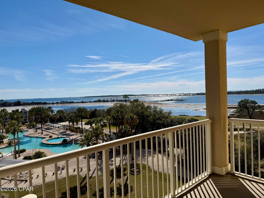 Experience FULLY FURNISHED luxury waterfront living in Panama City Beach!  Come see this turn-key, impeccably remodeled 3-bedroom, 3-bath condominium at The Grand in Bay Point, offering breathtaking views of the Grand Lagoon, Shell Island, and the Gulf. A large entry foyer leads into an expansive open living and dining area flooded with natural light and showcasing stunning views of both the water and the golf course. Enjoy luxury vinyl plank flooring throughout, crown molding, fully custom cabinetry, and beautiful lighting.  Designed for entertaining, the spacious layout flows seamlessly from the living and dining area into the gourmet chef's kitchen.  You have everything you could desire, including Wolf appliances, convection oven and microwave with gourmet modes, a Sub-Zero refrigerator, custom soft-close cabinetry, Kohler Prolific sinks with integrated accessories, under-cabinet lighting, and an oversized island, perfect for prep space, storage, and seating. Relax on your generous balcony and sip on morning coffee or evening beverage as you watch ships pass through the channel, boats returning to the marina, nature and wildlife, or even a dolphin playing below!  Your waterfront primary suite offers balcony access, serene water views, and a spa-like bath complete with dual vanities, custom cabinetry, a free-standing soaking tub, oversized shower, separate commode room, linen storage, and a large walk-in closet. Enjoy a split floor plan, with 2 additional guest suites each with private full bath, ample storage, and large windows.  Lots of natural light and beautiful golf course and water views everywhere!  Additional conveniences for storage include a well-appointed laundry room with pantry space, as well as a separate storage area close to your unit that is heated and cooled  This sixth-floor residence is tucked quietly at the end of the hall near the elevators and stairs. The Grand offers resort-style amenities including a luxurious pool, hot tub, grilling area, firepit, fitness room, game spaces, dining areas, and an owner's lounge. A deeded parking space and a large climate-controlled storage unit just steps from the front door complete this exceptional property. Call us today and make this your next home!
