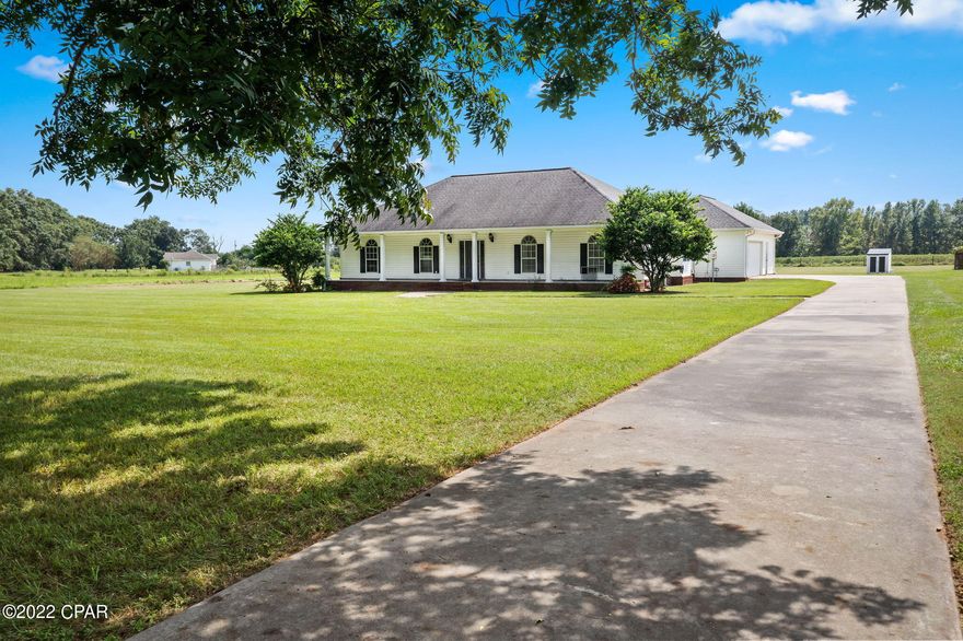 ****CURRENTLY UNDER CONTRACT, SELLERS WILL CONSIDER BACK UP OFFERS.**** This beautiful spacious 4/2 home is located just outside of Graceville, Florida and minutes from the Alabama line. Lots of updates include interior painting, tile flooring, bathroom vanities, kitchen pantry and crown molding. 

The oversized kitchen has lots of custom cabinets, a coffee bar, and separate dining room. 

Other features include a living room fireplace (gas logs needed), french doors going out to the back yard, large master bedroom, master bath with jacuzzi tub and separate shower. 

Off of the kitchen is a large laundry room, a double car garage and an office area with an AC unit. 

Outside features are 3.43 acres, (survey in office), an 36x24 outbuilding with an 8x8 roll up door, and paved road frontage.