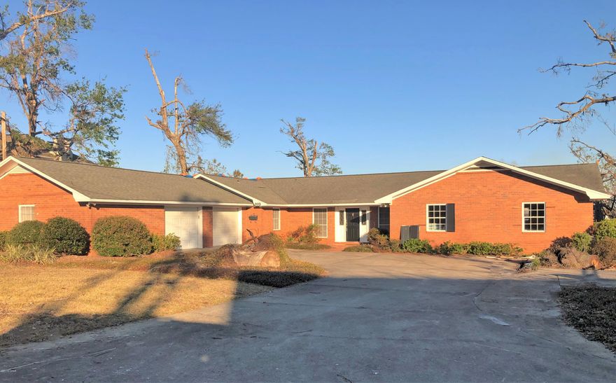 This one owner Waterfront home in the Cove is being offered for sale for the first time since the 1970's. Hurricane Michael damage required the seller to remove the flooring, sheetrock on the walls and ceilings and all appliances from the kitchen. Seller has decided to discount sell home in that condition.  Great news is you can be in charge of making the interior how you want it finished. The floorplan offers formal living and dining rooms plus a large family room off the kitchen. All bedrooms are spacious and located on one side of the home. The dock is still there but will need some work to it and the boat house. The oversized two car garage also has a 10x20 workshop built in. If you have been looking for waterfront, this home is a great start.