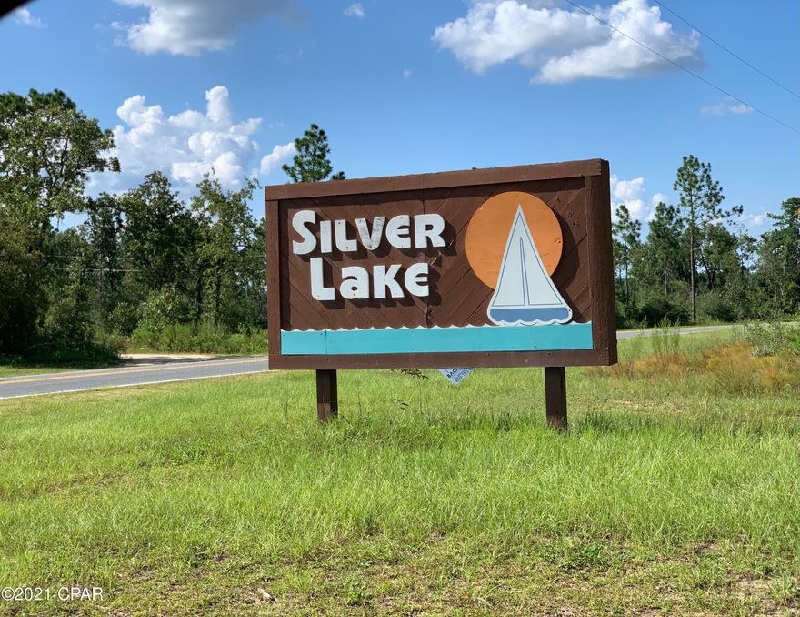 Motivated Seller!Charming home nestled in the Silver Lake Community. Surrounded by a hidden treasure, the 242 acre Seventeen Mile Pond, named the 2nd cleanest spring fed water feature in Florida by the University of Florida. No HOA!! This 2 bedroom, 2 bathroom home with 3 year old metal roof, detached garage and plenty of parking sits on 8 partially wooded acres on Jones and Horse Farm Road. Private access is limited to the homeowners and guests of Silver Lake where they launch their gasoline free boats, go swimming, freshwater fishing and enjoy family picnics. The updated kitchen with white cabinets compliment the natural daylight flowing through the windows. Wood look vinyl plank flooring in the living room and bedrooms with vinyl tile in the kitchen, laundry room and bathrooms. Listen nature from the covered front porch swing, a cup of coffee in hand or sit out in the open on the side porch that leads to an additional entry door into the laundry/mud room and entrance to the kitchen/dining room. The guest bathroom off the hallway plus 2 closets provide additional storage options. The Master bedroom ensuite with walk-in closet contains an additional closet in the Master bathroom. The guest bedroom with a sizable closet is situated off the living room. The oversized living room is equipped with a gas fireplace. The septic was recently serviced and the well provides excellent drinking water straight from the tap. No bottled water needed! Hang your stockings and cozy up to the gas fireplace on an occasional cool winter night. Spread your wings and create new memories with family and friends, South of I-10 in the Silver Lake Community, just North of the Bay County line in Marianna, Florida. Hope School is PreK-12th. Call your favorite Realtor® today and schedule your private showing!