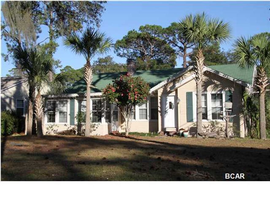 You'll love this place! This classic Florida Cottage in the ever popular COVE, a quiet neighborhood in a great location, is an easy bike ride or drive to the historic waterfront in downtown Panama City, FL. This home has been completely and tastefully updated. It is a classic split bedroom design on a large corner lot, with ample parking for four cars - two under the carport, and a fenced back yard. From the moment you enter, you will appreciate the original hardwood floors throughout the main living areas, and the 1930's craftsman architectural features. Picture yourself relaxing in the sun drenched enclosed porch that can double as a study or den. The recently remodeled and updated master bedroom contains a huge walk-in closet and french doors that lead you to a private patio where
