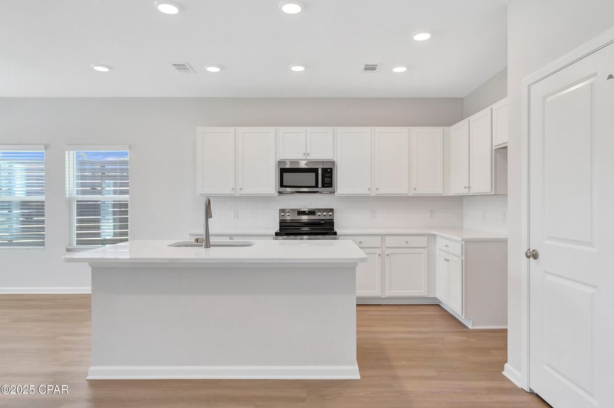 NO RENTAL RESTRICTIONS!!! Waypoint by Traton Homes, a vibrant new community of townhomes located on Front Beach Road in Panama City Beach, Florida. Waypoint offers 72 homes just under 3 miles from the beach, 1.5 miles from Dolphin Bay, and approximately 20 miles from the Northwest Florida Beaches International Airport. Residents will enjoy easy access to local attractions, with Pier Park only 7 miles away and Hathaway Bridge nearby, serving as the gateway to Panama City proper. The community is also conveniently situated near the Naval and Coast Guard bases.  Each townhome features 3 or 4 bedrooms, including a bedroom with a full bath on the main level. The open concept living space includes a modern kitchen with an island, a dining area, and a family room that opens to a private back patio. Upstairs, the spacious owner's suite offers a walk-in closet, and an ensuite bath with a double vanity, a shower, and a separate water closet. Two additional bedrooms, an additional full bath, and a conveniently located laundry room complete the upper level.