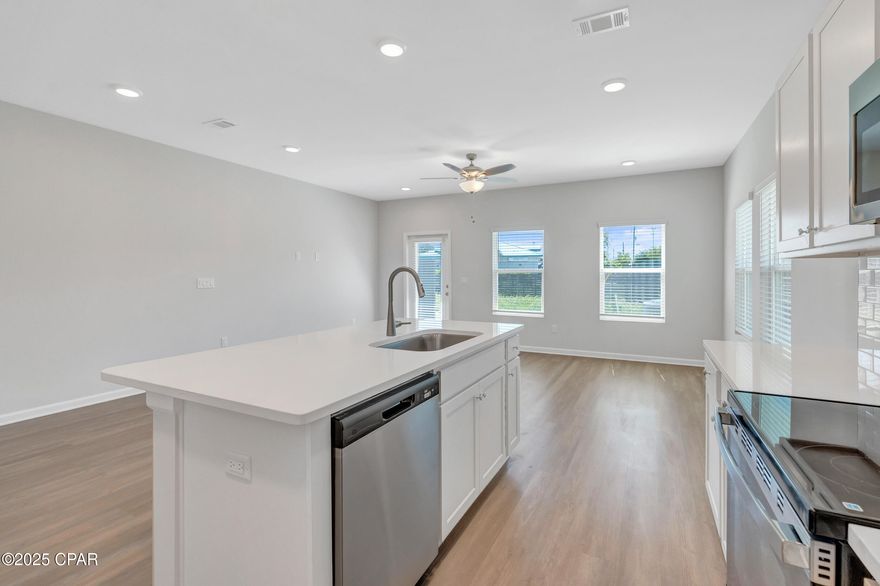 NO RENTAL RESTRICTIONS!!! Waypoint by Traton Homes, a vibrant new community of townhomes located on Front Beach Road in Panama City Beach, Florida. Waypoint offers 72 homes just under 3 miles from the beach, 1.5 miles from Dolphin Bay, and approximately 20 miles from the Northwest Florida Beaches International Airport. Residents will enjoy easy access to local attractions, with Pier Park only 7 miles away and Hathaway Bridge nearby, serving as the gateway to Panama City proper. The community is also conveniently situated near the Naval and Coast Guard bases.  Each townhome features 3 or 4 bedrooms, including a bedroom with a full bath on the main level. The open concept living space includes a modern kitchen with an island, a dining area, and a family room that opens to a private back patio. Upstairs, the spacious owner's suite offers a walk-in closet, and an ensuite bath with a double vanity, a shower, and a separate water closet. Two additional bedrooms, an additional full bath, and a conveniently located laundry room complete the upper level.