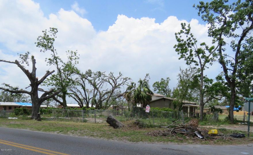 This is a great corner lot to build a new construction home. This centrally located property is close to shopping and also close to the worlds most beautiful beach!  The lot already has water and sewer hook up in place. The owner has also already completed tree and debris removal. Don't miss your opportunity to own this affordable property.