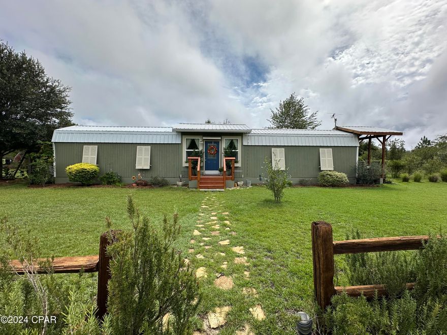 A nature lover's dream.  This Florida Cottage on 16 acres has everything needed to live off the land and enjoy all nature has to offer.  This 720 Sq. Ft. 1 Bedroom 1 Bath cottage and 12 X 24 detached guest cabin is perfect for downsizing while still having all the amenities and all the outdoor fun.  The home features a spacious master bedroom and bath with an on-demand water heater and a living room kitchen combo with a fireplace, complete with a private entrance to a beautiful sitting porch.  Connecting the two areas is a grow room for entry into the home and exit out onto a spacious outside deck, outdoor kitchen and outdoor shower.  If you have guest, you're in luck, behind that is a guest cabin with a bunk room, kitchen and a full office.  Outside features a bounty of hard work and a love for gardening and nature around every corner.  From potted plants, a large variety of fruit trees and herb bushes, to planted trellises, a green house and even an outdoor bathtub, this is something to see.  Additional exterior features include the pole barn that is attached to the cabin with a storage and workshop area, a man-made pond, a chicken coop and run area, large water trough container for ducks and walking trails.  Make an appointment today to view this meticulously thought-out natural paradise and see all it has to offer.