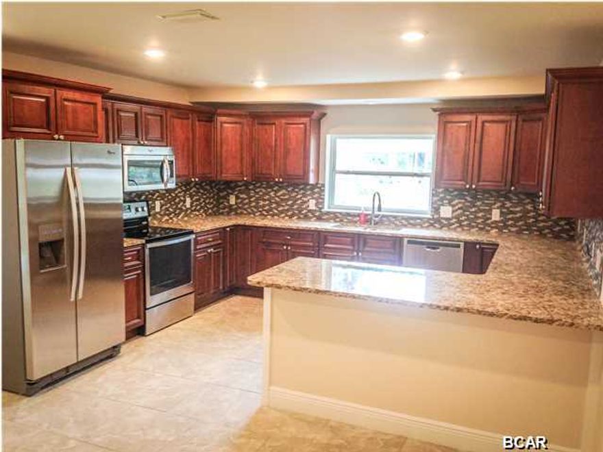 I am 805 E 2nd PL, when my current owners found me I WAS in sad shape, luckily they are seasoned renovators that brought me back to life and truly MOVE IN READY and even better than that....Can you believe my effective year built is now 2014! I'm a completely renovated BRAND NEW HOME! I have 3 bedrooms and 2 bathrooms. Look at my new metal roof. I have new freshly paint walls and ceilings in every room. I have beautiful 20'' porcelain tile in the great room, hallway and bathrooms, and brand new carpet in the bedrooms. Seriously, everything is new except for my super solid concrete block walls! New plumbing, new electrical, new water heater, new AC, new windows, new insulation, new everything. My Kitchen features new all wood cabinets, granite counter tops, an under mount sink, a