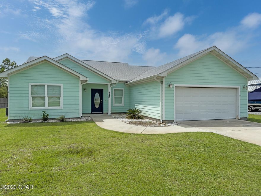 This 3 bedroom 2 bath Mexico Beach home has been completely remodeled. You will love this home the minute you step foot into the front door. The color palette was chosen to reflect the beauty of the emerald green waters of Mexico Beach which is just .5 miles from this home. This home features a brand new kitchen with Calacatta quartz countertops, beautiful herringbone backsplash, a nice island, loads of counter space and cabinet space, single bowl granite composite sink and higher end stainless appliances featuring a natural gas range. All of the flooring has been replaced with luxury LVP in the living, dining, kitchen and newly added third bedroom (seller added a closet). The other two bedrooms feature new plush carpet. Both the master bath and hall bath have ceramic tile. The hall bathroom is full size with a tub and stylish tile tub surround all the way up to the 10 foot ceilings. The master bath has a large walk in shower with a glass door, it is also tiled all the way to the 10 foot ceilings. The master bath also features a his and her vanity with hers being nearly 8 feet wide, while his is 4 feet. The master bedroom is large with vaulted ceilings, the secondary bedroom also features tray ceilings. There is also a large storage shed with a power and includes a window unit AC. Central HVAC is a newer Carrier unit and the home also has a tankless natural gas water heater. There are too many features to list so put this on your list to see!