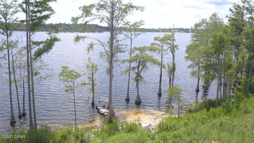 RARE FIND ON COMPASS LAKE WATERFRONT LOT WITH 1.2 acres mol.  These are very rare to find and as big as this one is. Beautiful home site with swimming area.  Lot is cleared and ready to build or Mobile Homes are ok.  No deed restrictions.  Ready for a dock and all the water toys and boats.  Make this your weekend getaway or permanent home.  Enjoy breathtaking views here everyday rain or shine.  Fish, swim, ski or pleasure boat rides are spectacular.  Enjoy dining close by at Olie's restaurant or Water front dining from your own home or dock. Panama City Beach is only 42 miles away.