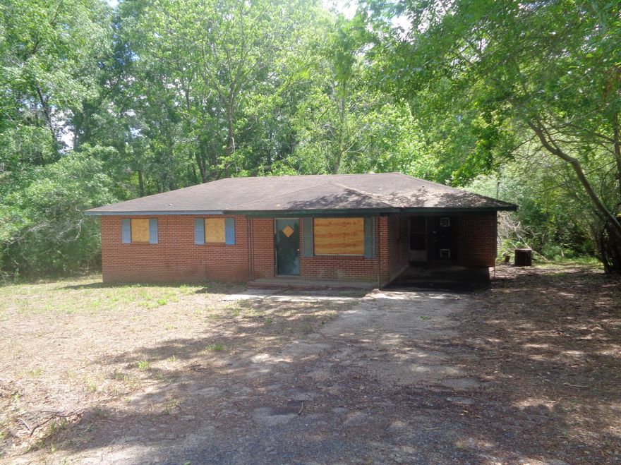 Handyman special 3/1 investment opportunity located within Bonifay, nestled at the end of a quiet dead end street. This brick home features an open kitchen/living area, large master bedroom, 1 car under roof carport, and lush Florida flora across a large lot!  All Information recorded in the MLS is intended to be accurate but cannot be guaranteed, buyer advised to verify. Sold As-Is. No utilities will be turned on to this property and only cash/renovation loan offers with 0 day inspection period will be considered. Buyer should perform their due diligence/necessary inspections before submitting an offer.