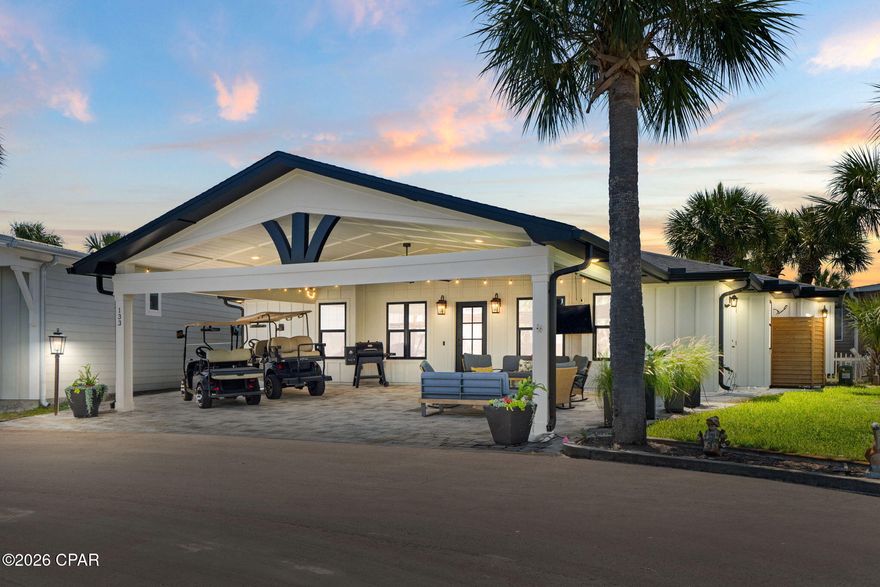 This is where vacation never has to end. Welcome to Venture Out, the legendary community nestled between Lower Grand Lagoon and the Gulf of America, where nearly six decades of memories have been made on sugar-white sand and sun-warmed docks. This 2021 custom build sits on a peaceful cul-de-sac and offers 3 spacious bedrooms, 3 baths, and 1,508 thoughtfully designed square feet. The massive 28x22 covered front porch -- finished in Flagstone pavers -- is built for the way you actually live here: golf carts parked, grill going, friends gathered, sun setting. Step inside to a home where artistry meets craftsmanship. A curated coastal palette sets the tone for unique quartzite counters, an eccentric backsplash, stainless single-basin sink, Frigidaire Galaxy appliances, brick veneer and tile accent walls, high-end LVP, and an oversized living room fan that keeps the breeze flowing. Built smart with spray foam insulation, central vacuum, 3-ton HVAC, Hardie board siding, hurricane-rated windows and doors, and pocket bathroom doors that maximize every square foot. Outside your door: Gulf front pool and clubhouse with private beach access, lagoon front pool, playground, tennis courts, marina, dock, boat landing, overflow boat/trailer parking, and a private gate to Pirates Cove Marina. St. Andrews State Park, Schooners Last Beach Bar, Patches Pub and Deckhand Social are all a short walk, bike ride, or golf cart cruise away. Queen sofa bed, outside shower, laundry room, storage room, outdoor storage chest and cabinet -- and yes, the golf cart conveys. Beach lover. Boater. Both. Whichever you are, Venture Out is the answer.