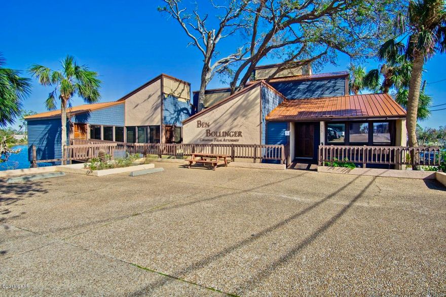 Price just reduced by $50,000! Waterfront office building with prime location that can not be duplicated. It is situated directly across the street from the Bay County courthouse and offers a large reception area, one and a half baths, conference rooms, storage rooms, waterfront offices and is ready for immediate occupancy. There is also a upstairs studio apartment with water views. The 3 waterfront lots next to the building are also for sale for someone who needs to expand or requires additional parking.