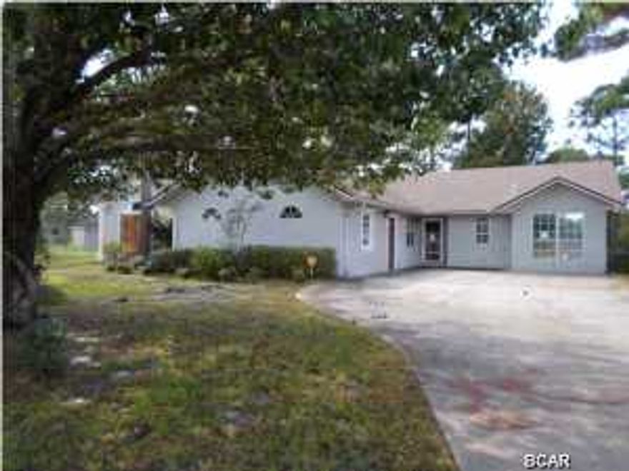 Don't miss your opportunity to own a lovely, large 4 BR home, located in the Cape Plantation area of Port St. Joe. This home has everything a large family needs: An open floorplan with kitchen/living/fireplace and dining room/sunroom, all in view. The master suite opens to the large screened lanai on the rear of the home and there's a mother-in-law or teen suite, complete with it's own bedroom/bath/private entrance. Plus a huge 2 car garage, complete with an ''oil change'' station, in the floor, yep, you drive right over it, just like at the retail shops! There is plenty of parking and a lovely, tropical yard for 2-legged and 4-legged kids. Only a mile from the water, so fishing and boating are minutes away. (All info/dimensions/etc are approximate. Buyer to verify ANY and ALL info