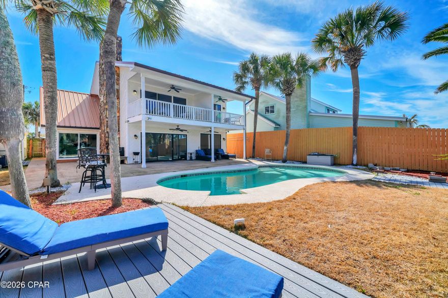 ***OPEN HOUSE! SAT, MAY 2 from 10AM-12PM*** Experience the ultimate waterfront lifestyle with this fully remodeled coastal retreat on Grand Lagoon! Ideally positioned just minutes from the Gulf, this exceptional property offers a rare combination of modern luxury, deep-water access, and outstanding short-term rental potential, all with no HOA restrictions. 

Thoughtfully renovated from top to bottom, the home features 5 bedrooms and 4 full bathrooms, including a spacious converted garage that serves as a private fifth bedroom with its own en-suite full bath. This flexible space can also function as a game or hobby room, making it ideal for maximizing rental occupancy and guest experience. The layout is well designed with two bedrooms on the first floor and the primary suite plus two additional bedrooms on the second level. 

Upon entering, the bright, contemporary design showcases fresh paint, updated lighting, and stylish fixtures throughout. New flooring flows seamlessly across the home with no carpet, creating a clean and low-maintenance environment ideal for both full-time living and high-traffic use. The fully redesigned kitchen is a standout, featuring white cabinetry, sleek countertops, and brand-new appliances that offer both style and functionality. Two of the three upstairs bedrooms feature private balconies with water views.

Outdoors is resort-style living at its finest! The backyard is built for entertaining, complete with a gunite pool, relaxing spa, and multiple levels of newer Trex composite decking all with lagoon views. For the boating and water enthusiasts, this property is exceptionally well equipped with deep-water frontage and an incredible covered dock! One side features a 40' x 20' roof over a 24,000 lb boat lift that can accommodate approximately a 35' boat. The second dock includes a 16' x 24' roof over a 12,000 lb lift suited for up to 21'. Two jet ski float pads provide additional convenience and storage. This convenient location provides easy access to St. Andrews Bay, Shell Island, and the Gulf. 

Situated on a quiet stretch of South Lagoon Drive and only a few blocks from the area's renowned beaches, Rick Seltzer Park, and multiple dining options, this property is ideally positioned to capitalize on Panama City Beach's strong vacation rental demand. Whether utilized as a primary residence, second home, or income-producing investment, this turnkey waterfront property delivers exceptional versatility and value. Schedule your showing today. A walk-through video is available