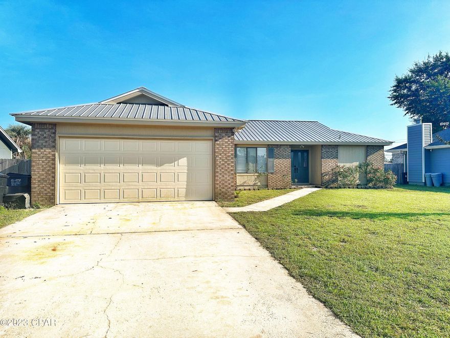 Beat the heat of high electric bills with this Affordable all-brick home.  Nearly $40k SOLAR PANELS installed this year— SELLER WILL PAY THEM OFF WITH AN ACCEPTABLE OFFER!  So this home has everything on your checklist: great big privacy-fenced yard, two-car garage, metal roof, large screened back porch, open living area that includes a breakfast bar and cozy fireplace, and energy saving solar power— all conveniently located in a sweet little neighborhood. Kids can easily walk to Bay Haven Charter School and Mosley HS is just down the road. A/C and most appliances are less than 5 yrs old. Solar panels cover most power bills for only $100 mo., adding to the affordability of this home. New tile in the family room/kitchen/dining area. Beautiful new epoxy resin countertops and breakfast bar. Dining room boasts wetbar and storage. Master suite features walk-in closet, private bath, and access to the screened porch. Property is conveniently close to the main access roads leading to all points of Bay County— Tyndall Air Force Base, Hwy 231 and North Bay County, Lynn Haven, Deerpoint Reservoir, Downtown Panama City, and Panama City Beach.  Would make an outstanding starter home, retirement retreat, or rental investment property. Also zoned for USDA Rural Development 100% financing for qualified buyers. Make your appointment to see this home today!