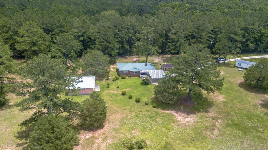 3 Homes on 2 Acres! 2 Houses & 1 Mobile located on property. Plenty of room for horses, fun, gardening. You name it! Main house has solar panels on roof top, builder plans available for finish construction of second brick home. Homes are in very nice condition. Live in one and rent two out, or rent all 3. Conveniently located to the heart of Marianna. Owner will Consider Owner Financing with 20% Down Payment. Investment Opportunity!