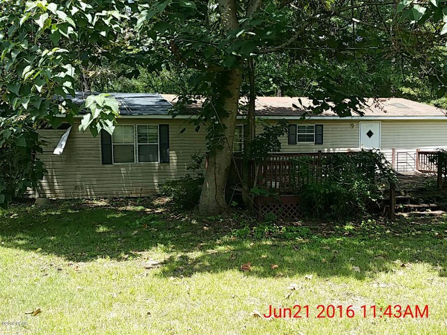 3-Bedroom, 2-Bath doublewide mobile home approximately 7 miles east of Marianna.  Large front deck and handicap ramp leading to side entrance.  Has island kitchen, fireplace, and garden tub in master suite.  This home will need repairs to make habitable.