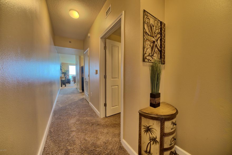 Million Dollar Views from this premium one bedroom with a bunk room GULF FRONT unit located in one of premier resorts in Panama City Beach. Soft neutral tones throughout, complement the exquisite décor as you enjoy the gorgeous sunset views! INCLUDES A DEDICATED, COVERED PARKING SPACE. Great primary residence, vacation home, or investment property. This resort has lots of amenities, including almost 500' of Gulf frontage, a million dollar Gulfside, zero entry lagoon-style pool, sauna, fitness center with health bar, indoor heated pool, full service spa, game room and video bank, media room, and more, surrounded by beautiful exterior details.