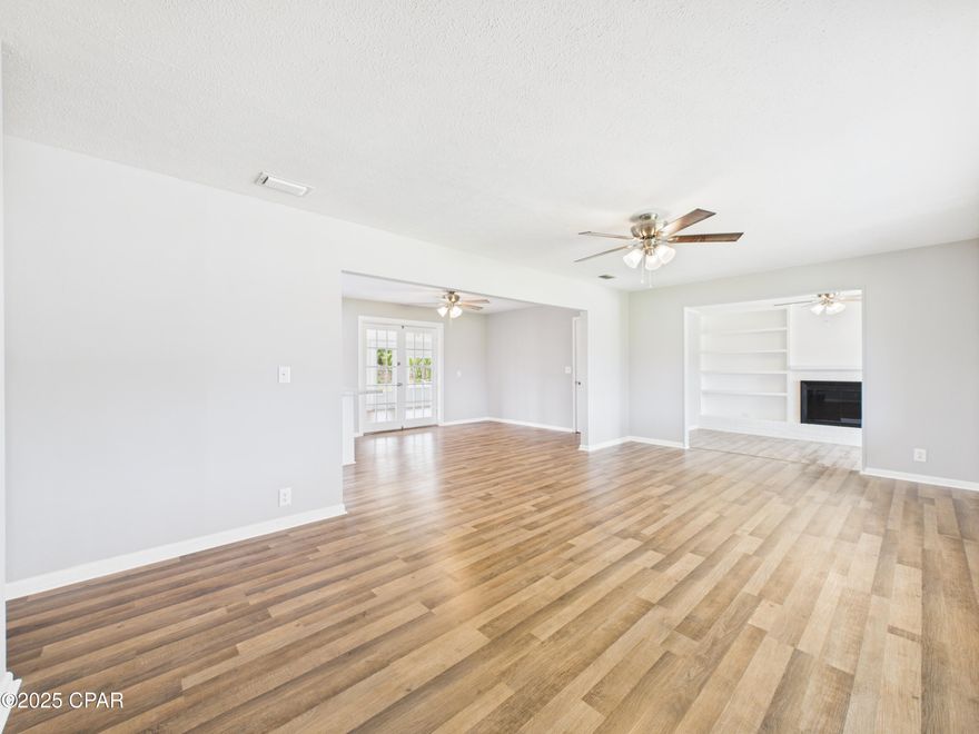 Welcome to your freshly remodeled, spacious home.  Home has been completely redone and features herring bone backsplash tile, new soft close cabinets and counters and gleaming stainless steel appliances.  Custom tile in both bathroom showers, pebble floor in master shower, new vanities and toilets, brand new 15.2 seer Goodman HVAC system with 10 year warranty will make for highly energy efficient bills.  New water heater, roof was done July 30, 2020.  New LVP flooring was installed for beauty and ease of maintenance.  Wood burning fireplace with custom built in shelves on either side of the fireplace. French doors lead to the Florida room on the back.  There is a new mini split system coming in the enclosed back porch room, adding an additional 240 heated and cooled square footage.  House has been freshly painted inside and out and features a brand new garage door.  New insulation blown in to achieve full R30 insultation rating, making for low electric bills.  Some new windows have been added and new ceiling fans throughout.  Gigantic laundry room/mud room is unusual to find these days in newer construction.  Large back yard makes for many possibilities, including an inground pool.  There is a well in place for no cost irrigation!  Large front driveway would easily accommodate at least 4 cars, possibly 6 depending on size.  Garage has been freshly drywalled and painted and is a very deep garage, where far more than a single car would fit.  Make this newly remodeled home yours today!