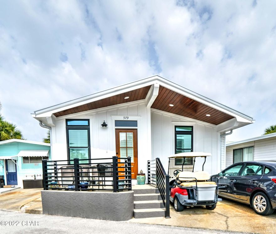 CURRENTLY UNDER CONTRACT, SELLER ACCEPTING BACKUP OFFERS Check out this great 3 bedroom, 2.5 bath stunning beach house just steps from the beach!  Everything here is new including:  roof, front siding & front door, new porch railings, interior doors, flooring, cabinets, countertops, back splash, fireplace, smooth ceilings, paint, appliances... and more! You will love the large kitchen with breakfast bar and nice size living room. The front porch is great and offers plenty of room for grilling and relaxing after a long day at the beach. It doesn't get better than this! Venture Out is a golf cart community that has 300' on the beautiful pristine beaches of the Gulf of Mexico and 1,000' on the Grand Lagoon. Venture Out has something for everyone. With two pools (one heated), fishing pier, boa