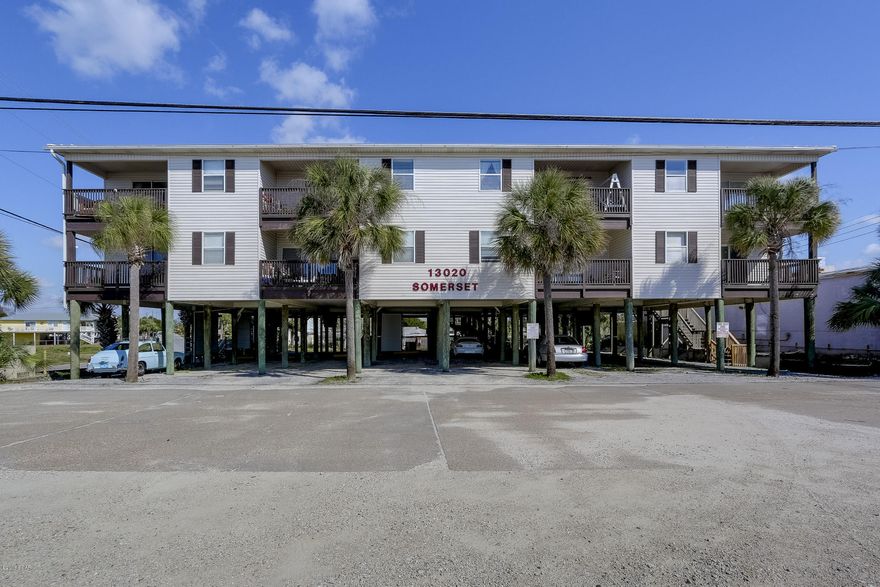 Somerset Gulf View Condo on Front Beach Road! This 2nd floor, 2 bedroom/2bath condo has covered parking under building and large balcony that has beautiful view of the Gulf. End unit with generous living and dining combination open to kitchen with a breakfast bar. Utility room has hookups for W/D. Property needs a little TLC with new flooring , paint and updates of your  choice. You will be able walk to beach, shops and restaurants!