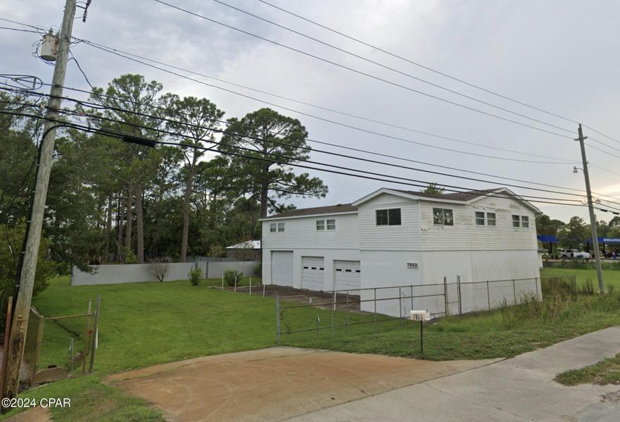 MOTIVATED SELLER WILL CONSIDER REASONABLE OFFERS
 Prime location on Panama City Beach Parkway. Almost 1 acre lot with building.  Building was used as garage space for a wrecker service on bottom floor, and the owner's home on the 2nd floor. Zoned C-3 General Commercial, there are many acceptable uses for this property. Buyer to verify which uses are allowed.
*Interior of building is not available for showings at this time, but feel free to view property and exterior of building.