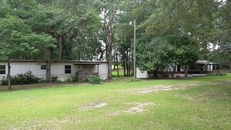 ATTN INVESTORS! 2 Homes For the Price of 1. Live in one and rent the other or use it as a mother-in-law apartment! Two single-wide mobile homes on 2 acres in great location just 2-1/2 miles from downtown Bonifay. Total of 4 bedrooms, 3 baths. Each home has been well-maintained, has 2 BRs and is skirted. One home has central heat but neither has air conditioning. #2253 was built in 1985, 952 SF, double-paned windows, split bedrooms & 2 full baths. The master bath features a double vanity, garden tub, separate shower along with a walk-in closet. #2255 is a 1983 MH, has 784 SF & a 20'x10' front porch. Good sized shared open front yard with shady back yard. The homes share a large septic tank and water well yet each is on a separate electric meter. Warm weather plus FL has NO state income tax!