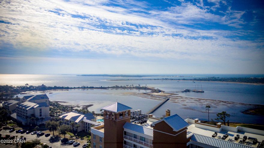 UNDER CONTRACT WITH CONTINGENCY; SELLER ACCEPTING BACK UP OFFERS.

Experience unparalleled privacy and Bayfront serenity from this exemplary legacy offering located in Reflections luxury condominiums.  Reflections is one of the most exclusive locations along the Emerald Coast surrounded by St. Andrews Bay with views of St. Andrews Bay, the Gulf of Mexico, and Grand Lagoon.  701 Reflections is offered fully furnished and has been beautifully and thoughtfully updated, yielding an elegant and refined bay front retreat characterized by timeless finishes.  Perched at a high elevation, with unencumbered, pristine Bay, Gulf, and Lagoon views, this condo was beautifully updated with high-end finishes, furnishings, and decor by the owne Uniquely positioned on the southeast corner of Reflections with a balcony that spans the entire length of the condominium, this condo offers a unique view of the Bay Point Jack Nicklaus golf course and Shell Island in addition to unparalleled water views.
This beautiful condo offers a view and easy access to a private pool and pool cabanas for the ultimate in relaxation.  Short term rentals are allowed, however this condo has never been rented.
Other notable features include crown molding in living areas and bedrooms, all new Brazilian cherry hardwood floors in the bedrooms, new plantation shutters in the bedrooms, new paint throughout, updated LED lighting, new heating and air conditioning system, new hot water heater, new blinds in living room/dining room, and master bedroom, glare-resistant/mirrored film on select windows, new wine cooler, newer furnishings including leather living room sofas and recliner, as well as an additional storage pantry in the guest bedroom.  The owners spared no expense when choosing a pristine color palette and sophisticated interior design with professional decor.  
The master bedroom has a convenient sliding glass door leading directly to the balcony,  and windows with direct views to the water that are consistent throughout the primary living spaces. The adjoining master bathroom is strikingly outfitted with a beautiful vanity, and  large format tile in the shower.  There are four total bedroom suites including four private bathrooms and a half bath.  The chef's kitchen features newer sleek appliances with custom cabinetry and granite countertops open to both the spacious living room and the easily accessible balcony. The covered porches and floor to ceiling windows are consistent on both the east and west facing elevation allowing ample natural light to cascade throughout the condo.  Each bedroom is its own large suite with private bathroom. This condo comes with ample storage as well as a laundry room with newer/stackable washer and dryer, and private door to the balcony.  This condo is one of the most exclusive offerings in the marketplace and will allow a true luxury living experience with ample privacy and a coveted waterfront lifestyle. Reflections is tastefully nicknamed "the best of Bay Point" with timeless coastal architecture and stately homes along the water. This premium location allows great boating access as well as perfect positioning with quick access to Thomas Drive, and Panama City Beach Parkway, and all the world class restaurants, shopping and local entertainment that Panama City Beach is famous for.  Reflections lifestyle includes a 10,000 square foot resort style pool with hot tub and cabanas, Serenity Spa, Owners Lounge, exercise room, and is walking distance to Pelicans Restaurant, and Flip Flops Grill.  Come experience luxury living at its finest and make 701 Reflections yours today.