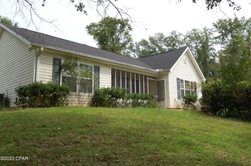 Lovely 3/2 with attached carport  situated on 2 1/2 acres with woods on either side. Large yard has an abundance of established ornamentals, perineals and some fruit trees. Large enclosed back porch with brick floor. Two storage buildings one of which has electric and is newer.