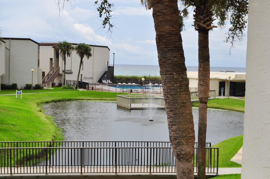 No waiting for elevators with this 4 bedroom, 3 bath Sugar Beach condo! This unit is move-in and rental ready!  Enjoy the view of the freshwater pond, pool and even the Gulf of Mexico from the first floor balcony off the living area. The kitchen has been updated with granite countertops and stainless steel appliances.  The Master Bedroom is on the second floor and has a private balcony with a pretty view of the pond and tennis courts. Lots of closet space inside this condo and there's even a laundry nook.  Sugar Beach is a gulf front complex with dedicated beach, inground pool, bar-b-q grills and picnic area, community room,  tennis courts, and  walking paths around the Koi/turtle pond. Park right outside your own unit and enjoy all the amenities Sugar Beach has to offer! All info is approx. and must be verified by Buyers if important.