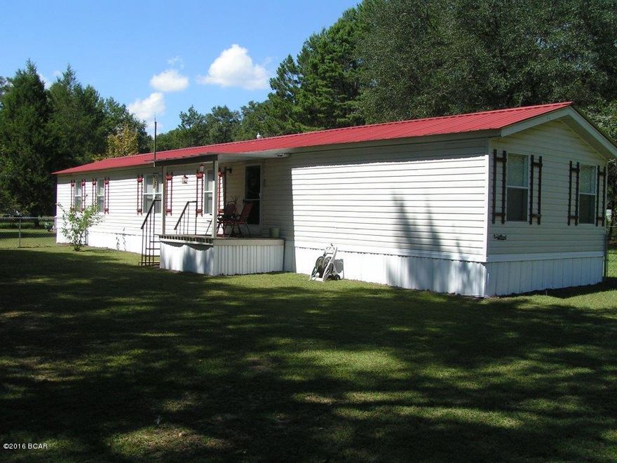 Very nice 3BR/2B mobile home nestled on 2.4 acres. Home features 2-2 car carports, large storage building, large stand alone shop, storm celler for safety and chain-link fenced back yard.  This property is perfect for someone who is looking for a little privacy in the country but is within close promoxity to Panama City, Marianna and Blountstown.