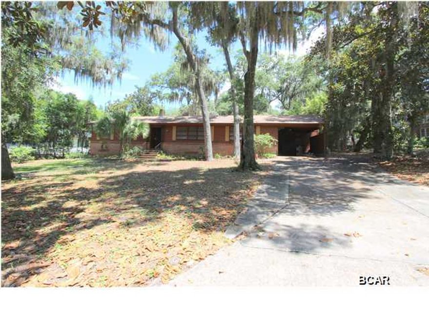 As they say in Real Estate - Location, Location, Location - and 603 Bunker's Cove certainly has it. This solid home sits in one of the most coveted neighborhoods in Bay County among the majestic Oaks and Magnolias and is close to Downtown Panama City, minutes to Bay Medical Center and within walking distance to St Andrews Bay Yacht Club. This home has been lovingly cared for and upon entering you step into a huge 36 X 14 Living Room/Dining Room combination with refinished wood floors - the beautiful wood floors run throughout the home except in wet areas, which feature new tile in the kitchen & laundry room. The kitchen also has new decorative tile work & backsplash, new dishwasher, new gas cooktop and freshly painted cabinets. Just off the kitchen is the den that features knotty