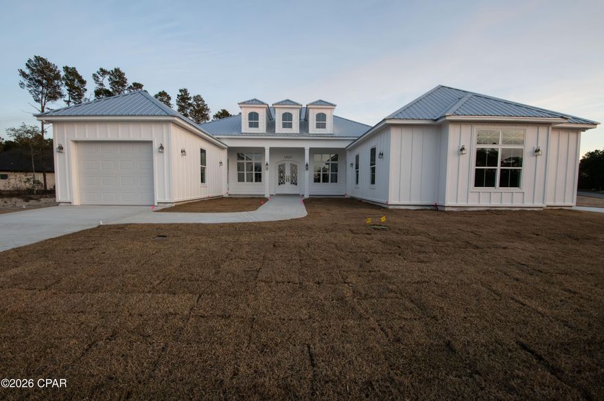 Welcome to the spectacular sandhills of North Bay county! Come visit this exquisite 3 bedroom 3 1/2 bath home located on a large 1.41 acre corner parcel across from the pristine spring-fed Bream Pond. The whole community has underground electricity and paved roads.  This masterful custom home is currently under construction and estimated to be completed around the end of this month. Recently installed is the captivating oversized French front door made from rod iron with an exceptional filagree design. The spacious great room has a expansive tray ceiling combined with the dining area and boasts an open floor plan. The back wall of this room has 8 x 16 ft. sliding glass doors that open to a large outdoor covered lanai that is ready for an outdoor kitchen and fireplace. It has a split bedroom plan with the master located on the east side of the home. This luxurious master bedroom has a tray ceiling and features an ensuite bathroom that includes 2 separate large walk-in closets, a striking walk-in tiled shower, his & her sinks separated by a middle vanity that are combined with tall end cabinets that are all custom designed with the same white solid wood cabinets used throughout the home. The back closet comes with a private pocket door that conveniently opens into the laundry room. Each of the additional bedrooms has their own ensuite full bathroom. The well-planned kitchen encompasses a breakfast bar island all stainless appliances, under-cabinet lighting, a gas cooktop with an industrial style hood vent, built-in stacked microwave and oven, dishwasher, french door refrigerator, and a generous walk-in pantry. Finishes include 8 ft. arched doorways, luxury vinyl plank flooring & white wooden cabinets with beautiful quartz counter tops. Outside is an in-ground gas tank that is plumbed to the lanai, kitchen and tankless gas water heater. Overall this home boasts a total of 4144 sq. ft. under roof. There are 2 attached garages- a double and a single to allow for 3 vehicles. It also includes a extra outdoor accessible storage room located at the rear of the home. This executive home is only 3 traffic lights (18 miles) away from the North Florida Beaches international airport with it's growing industrial park and new Hilton hotel. Bring your best offer and begin the new year with peaceful country living at it's finest!  Motivated seller!  Listing agent is related to the builder.