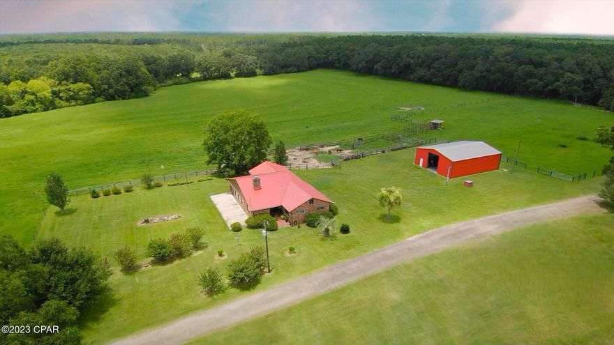 Presenting an impressive 166-acre farm with exciting development potential! It presents development opportunities with the potential to be subdivided into 1-acre lots. This property features a 3-bedroom, 2-bathroom home showcasing beautiful hardwood floors and tiled interiors. The house has seen recent enhancements, including a new metal roof, updated kitchen appliances, plumbing improvements, and more. Originally constructed in 1943, it underwent significant expansion and modernization in 2000, adding a master bedroom, bathroom, pantry, living room, and a sunroom area.

This farm is well-prepared for livestock and equestrian activities, surrounded by perimeter and cross-fencing. It offers numerous rolling pastures adorned with majestic Live Oak trees, and other hardwood trees, convenient driving lanes, 16-foot access gates, cutting and sorting pens, and five strategically placed ponds throughout the property.

Furthermore, this property features a substantial 150x52 Military Commercial Grade steel master multi-use building. It serves not only as a storage space for hay and other materials but also has the potential to house airplanes, helicopters, and various equipment. Additionally, there's a newly built 50x40 enclosed workshop with end-to-end roll-up doors for effortless loading and unloading. The property provides an extra 400 Amp service and an additional drilled well in the backside pasture, offering versatile utility options.

Please be aware that approximately 100 cows and 5 donkeys are not included in the sale but may be available for separate acquisition, if desired.