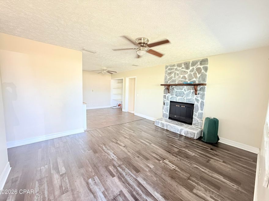 Welcome to this beautifully updated home in the desirable St. Andrews area of Panama City. This property combines modern upgrades with functional living, making it a standout option for comfort and convenience.

Inside, you'll find new luxury vinyl plank (LVP) flooring throughout, offering both durability and a clean, modern look. The kitchen is designed with soft-close cabinets, providing a high-end touch and everyday ease. A cozy fireplace adds warmth and character to the living space, perfect for relaxing evenings.

The home features a thoughtfully designed bathroom with a stylish barn door, adding both charm and privacy. Acoustic ceiling tiles enhance sound control, creating a quieter and more comfortable indoor environment, while tile flooring in key areas adds practicality and easy maintenance.

Step outside to a fully fenced backyard, ideal for pets, entertaining, or simply enjoying your own private space. The fire pit area creates the perfect setting for gatherings or unwinding at the end of the day.

For connectivity, the home is equipped with access to WOW! Fiber internet with 1 Gig speeds available for approximately $45/month, making it ideal for remote work, streaming, or gaming.

This home offers a balance of style, functionality, and value in a convenient location close to shopping, dining, and local amenities.