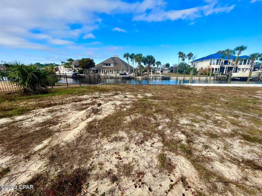 Why remodel an older home and find surprises, when you can build your NEW dream home on this large, cleared DEEP WATER ACCESS CANAL LOT in Bay Point, one of the premier communities in Bay County! One of the very few remaining vacant waterfront lots in Bay Point and not far down the canal from the Bonefish bridge. Build your custom dream home and dock your boat right behind your house and save dry storage fees! Lot boasts 36' of canal frontage where you can dock your boat. Conveniently located near the residents' gate off of Navy Boulevard. Bay Point is a gated, Nicklaus golf course and golf cart friendly community with activities and an on onsite bar/restaurant at the golf club with additional entertainment and dining options at the hotels within Bay Point, so you don't need to leave your neighborhood to enjoy live music or dine out! Point South Marina within Bay Point is a full services marina with a fuel dock. This home site is minutes away from some of the best restaurants in PCB, the Hathaway Bridge and also from the beautiful emerald coast and white sand beaches!  This is the perfect lot to build your own piece of paradise in PCB so you can live your dream where others vacation!

Survey is available. Please verify all information, if important.