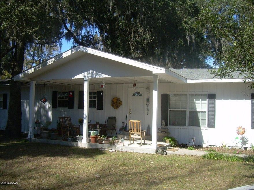 Nice home with views of the lake on just under 1/2 acre lot. With an oversized family/dining room, open floor plan kitchen and seating area...there's plenty of room for family time or just a weekend getaway! Beautiful Oak Trees, Orange Tree, stone fireplace, front and screened back porch with plenty of fishing just out your door! Upgrades in 2004 include, foam insulation, plumbing, roof, water heater, electrical, Ac- Heat pump.....Laundry room with cabinets galore! All appliances included!