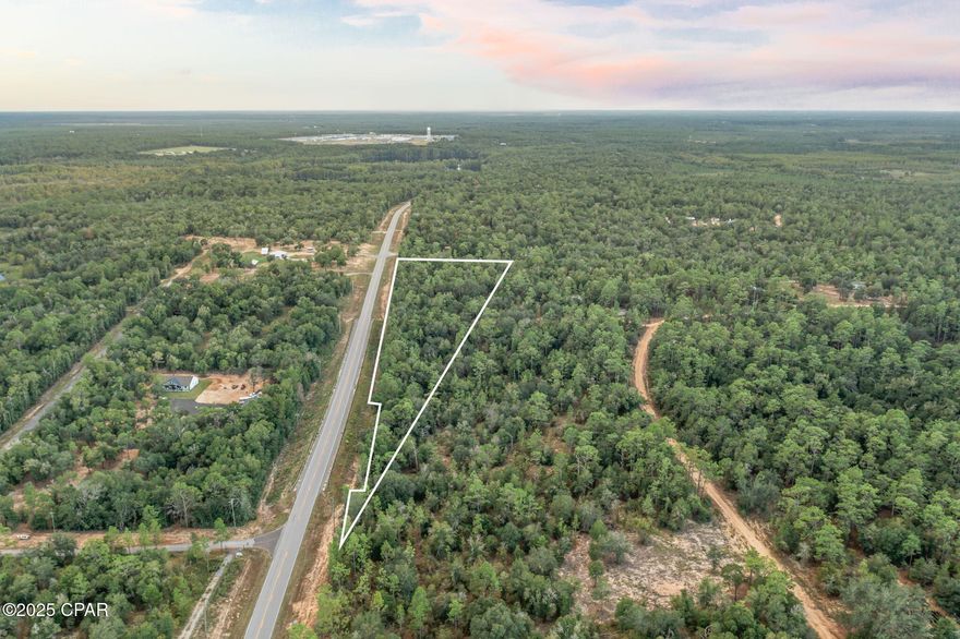 8.0± Acres of Opportunity with Highway Frontage!
Discover the perfect blend of convenience and natural beauty on this rolling 8-acre parcel, boasting elevated terrain and a mix of mature hardwoods and pines. Centrally positioned between Hwy 79 and Hwy 77, this location offers seamless access to nearby towns, schools, and amenities—ideal for those seeking both privacy and connectivity.
Just a hop and a skip from the sparkling waters of Holmes Creek, enjoy weekend canoeing, diving adventures, and peaceful nature escapes. Located just north of the Beaches, this property places you within reach of coastal fun while offering the tranquility of inland living.
Whether you're envisioning a private homestead, recreational retreat, or future development, this land delivers the topography, access, and lifestyle to make it happen.  Please note, no manufactured homes and a new survey will determine new legal of this cutout parcel.