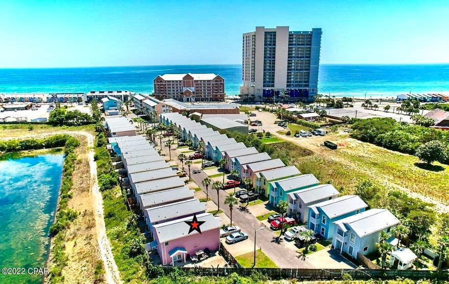 Last unit on the right, with not much traffic, and the biggest back yard in the whole complex. New roof was installed late 2019, with average $39K potential income projection. just a Short Walk Across the street to the White Sandy Beaches and Emerald Water of the Gulf of Mexico.the unit Features a large kitchen with Plenty of Cabinet & Counter Space, with breakfast bar, Laundry Room with Washer & Dryer, Dining Area, Spacious living room with custom built ins,  Fenced in Back Porch and Outside deck off the front Bedroom. This Small Complex includes 2 Pools, a Club House & Low Homeowners Fee. Located on West end of the Beach. Close to Pier Park, Shopping & Dinning. These units do not come on the Market Often. All ages, measuremen