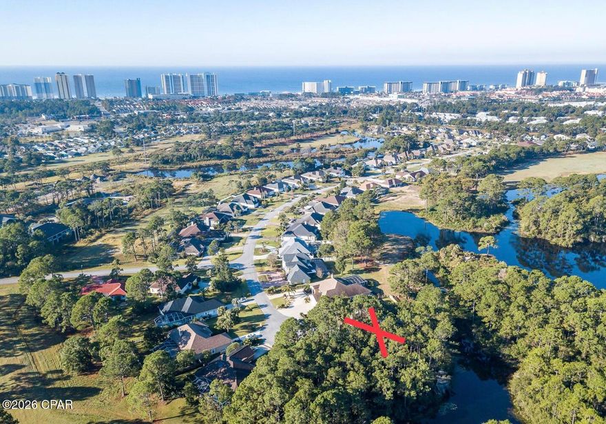 Ready for a CHANGE? CREATE your NEXT MOVE to a WONDERFUL LIFE on this INCREDIBLE  WATERFRONT HOMESITE, one of the last available in THE GLADES, one of Panama City Beach's most BEAUTIFUL ESTABLISHED communities. The CUL-DE-SAC setting comes with an impressive 144 feet of rear frontage offering TRANQUIL WOODED and WATER VIEWS! Build your custom dream home in a location that perfectly balances SERENITY and CONVENIENCE. Enjoy remarkably low HOA fees all while staying minutes from golf courses, bridge-to-town access, and a vibrant array of dining, shopping, and entertainment. New hospital and ancillary medical services are being constructed nearby as are retail and casual dining spots. A brand new DOLLYWOOD theater, TOP GOLF, and PIER PARK shopping and dining are minutes down the highway.  The location south of Panama City Beach Parkway places you within minutes of AWARD WINNING SUGAR SHORE and EMERALD WATERS as well as numerous UNIQUE GULF and LAGOON FRONT DINING destinations. For more convenience...THREE access points into THE GLADES, two at LIGHTED INTERSECTIONS! Another CONVENIENCE...retrieve YOUR MAIL at the end of YOUR OWN DRIVEWAY! This GOLF CART COMMUNITY is home to a great new addition, the POPULAR DUPLIN WINERY! Come pour a glass to CELEBRATE your DECISION to CHANGE your LIFE!